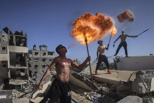 Các thành viên đội Bar Woolf của Palestine đến từ Gaza với màn trình diễn lửa trên đống đổ nát của một tòa nhà bị phá hủy bởi các cuộc không kích của Israel Các thành viên đội Bar Woolf của Palestine đến từ Gaza với màn trình diễn lửa trên đống đổ nát của một tòa nhà bị phá hủy bởi các cuộc không kích của Israel - Sputnik Việt Nam