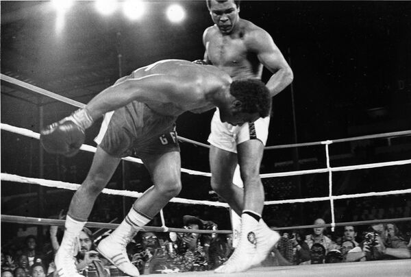 Đấu thủ Muhammad Ali, bên phải, theo dõi đương kim vô địch thế giới George Foreman ra sân ở vòng 1/8 của trận tranh đai WBA/WBC ở Zaire - Sputnik Việt Nam