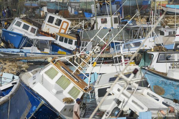 Ngư dân kiểm tra các tàu bị hư hại do Bão Beryl tại cơ sở đánh cá ở Bridgetown, Barbados - Sputnik Việt Nam