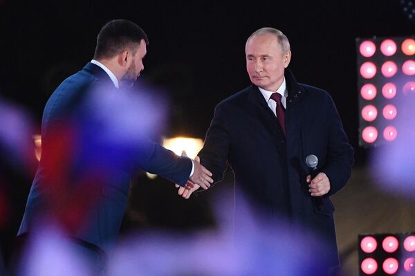 Ngày 30 tháng 9 năm 2022. Tổng thống Nga Vladimir Putin và người đứng đầu Cộng hòa Nhân dân Donetsk (DNR) Denis Pushilin tại buổi hòa nhạc vận động ủng hộ việc sáp nhập LNR, DNR, cùng các khu vực Kherson và Zaporozhye vào Nga. Ngày 30 tháng 9, Tổng thống Nga Vladimir Putin đã chấp thuận 4 chủ thể mới sáp nhập vào thành phần của Nga. - Sputnik Việt Nam