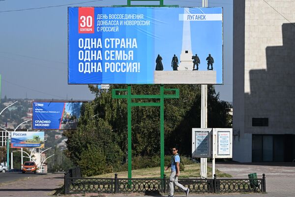 Tấm biển quảng cáo trên đường phố ở Lugansk nhân Ngày Thống nhất các khu vực mới với Nga. - Sputnik Việt Nam