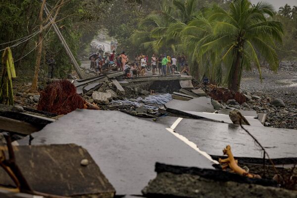 Người dân kiểm tra con đường quốc lộ bị phá hủy bởi siêu bão &quot;Fung-wong&quot; tại Dipaculao, tỉnh Aurora, Philippines - Sputnik Việt Nam