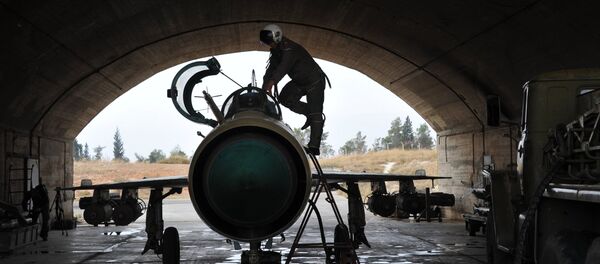 A Syrian pilot checks a MiG-21 aircraft of the Syrian Air Force before a mission at the Hama airbase near the city of Hama, Syria's Hama Province. (File) A Syrian pilot checks a MiG-21 aircraft of the Syrian Air Force before a mission at the Hama airbase near the city of Hama, Syria's Hama Province. (File) - Sputnik Việt Nam