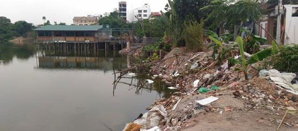 Khu vực Đầm Trị (quận Tây Hồ), nơi dư luận phản ánh có nhiều công trình không phép mọc lên. Khu vực Đầm Trị (quận Tây Hồ), nơi dư luận phản ánh có nhiều công trình không phép mọc lên. - Sputnik Việt Nam