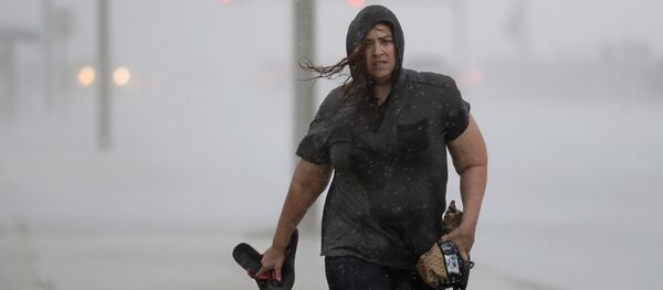 Hillary Lebeb walks along the seawall in Galveston, Texas as Hurricane Harvey intensifies in the Gulf of Mexico Friday, Aug. 25, 2017. - Sputnik Việt Nam