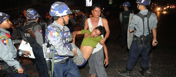 Полиция уносит пострадавшего во время антимусульманских погромов в Янгоне, Мьянма - Sputnik Việt Nam