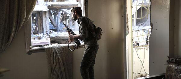 Một chiến binh của các lực lượng dân Một chiến binh của các lực lượng dân chủ Syria ở Rakka, Syria. chủ Syria,ở Rakka, Syria. - Sputnik Việt Nam