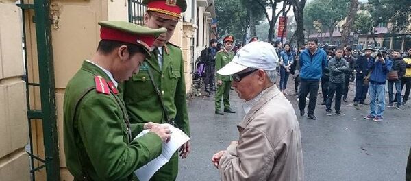 Ông Trịnh Xuân Giới, bố Trịnh Xuân Thanh đang đưa giấy mời để vào tòa - Sputnik Việt Nam