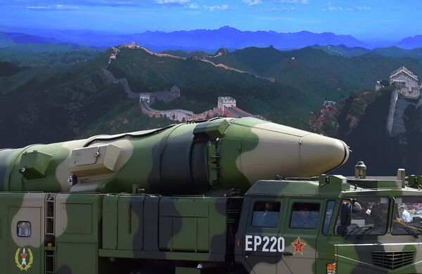 A military vehicle carries DF-21D missile past a display screen featuring an image of the Great Wall of China at Tiananmen Square in Beijing on September 3, 2015 - Sputnik Việt Nam
