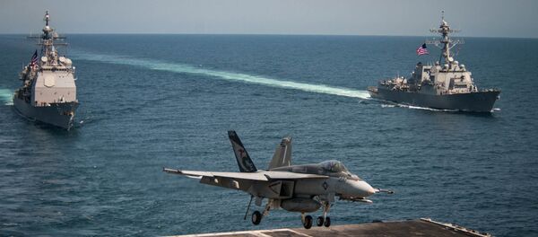 An F/A-18E Super Hornet lands on the flight deck of the U.S. Navy aircraft carrier USS Carl Vinson as the Ticonderoga-class guided-missile cruiser USS Lake Champlain (L) and the Arleigh Burke-class guided-missile destroyer USS Wayne E. Meyer transit the western Pacific Ocean May 3, 2017. An F/A-18E Super Hornet lands on the flight deck of the U.S. Navy aircraft carrier USS Carl Vinson as the Ticonderoga-class guided-missile cruiser USS Lake Champlain (L) and the Arleigh Burke-class guided-missile destroyer USS Wayne E. Meyer transit the western Pacific Ocean May 3, 2017. - Sputnik Việt Nam