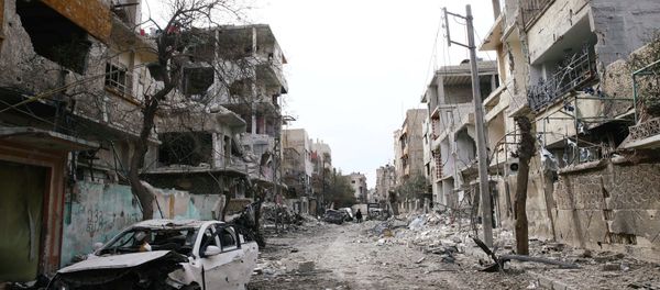 Damaged cars and buildings are seen in the besieged town of Douma, Eastern Ghouta, Damascus, Syria Damaged cars and buildings are seen in the besieged town of Douma, Eastern Ghouta, Damascus, Syria - Sputnik Việt Nam