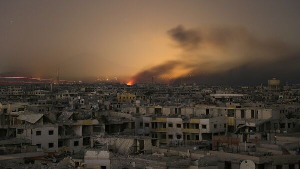 Lights and smoke are seen during Syrian government bombardment on the rebel-controlled town of Arbin, in the besieged Eastern Ghouta region on the outskirts of the capital Damascus, on late March 11, 2018 - Sputnik Việt Nam