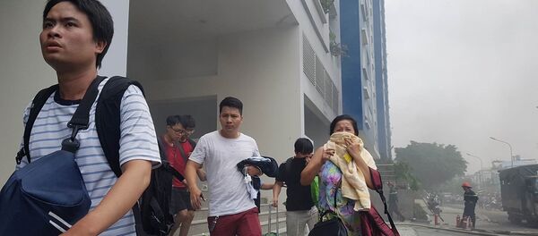 Người dân lại một lần nữa tháo chạy khỏi chung cư Carina Plaza khi ngọn lửa tái bùng phát vào trưa 23.3 - Sputnik Việt Nam