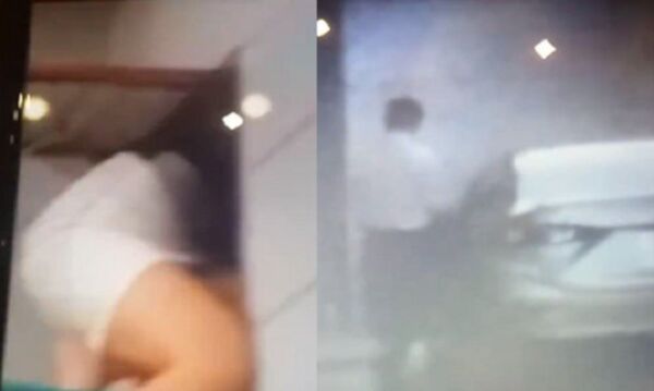  Hình ảnh người phụ nữ đang chui qua lỗ thông gió, còn người đàn ông cho là ông Thuân nhanh chóng bỏ ra phía chiếc ô tô và rời đi - Sputnik Việt Nam