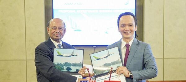 Chủ tịch Tập đoàn FLC Trịnh Văn Quyết và Phó Chủ tịch Boeing Dinesh Keskar thực hiện lễ ký kết. - Sputnik Việt Nam