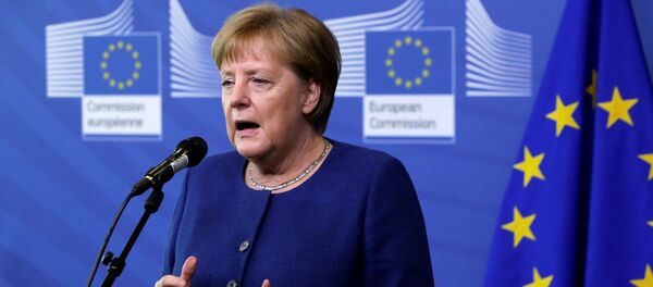 Germany's Chancellor Angela Merkel addresses media representatives as she arrives ahead of a summit at EU headquarters in Brussels on June 24, 2018 - Sputnik Việt Nam