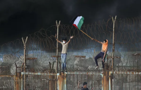 Người biểu tình Palestine trên hàng rào kim loại ở biên giới ven biển giữa Israel và Dải Gaza Người biểu tình Palestine trên hàng rào kim loại ở biên giới ven biển giữa Israel và Dải Gaza - Sputnik Việt Nam