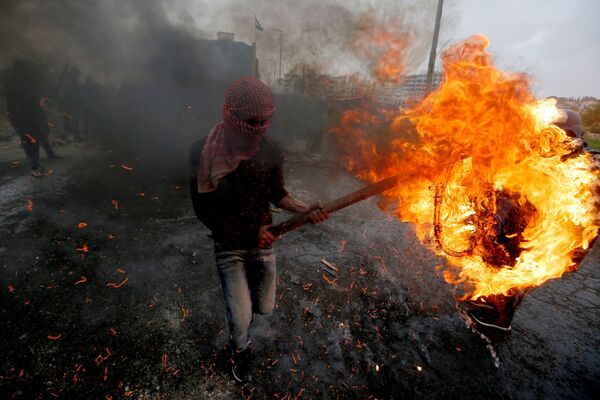 Một người Palestine đụng độ với lực lượng Israel gần khu định cư Do Thái Beit El ở Bờ Tây - Sputnik Việt Nam