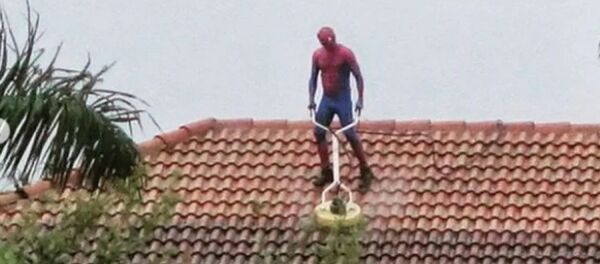 Người nhện rửa mái nhà trong cơn mưa bão - Sputnik Việt Nam