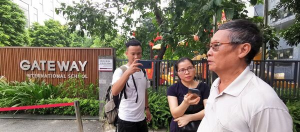 Phóng viên phỏng vấn người dân tại cổng trường Quốc tế Gateway. Phóng viên phỏng vấn người dân tại cổng trường Quốc tế Gateway. - Sputnik Việt Nam