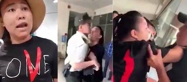 Đại úy Lê Thị Hiền xô xát, chửi bới nhân viên sân bay Tân Sơn Nhất. Ảnh cắt từ clip Đại úy Lê Thị Hiền xô xát, chửi bới nhân viên sân bay Tân Sơn Nhất. Ảnh cắt từ clip - Sputnik Việt Nam