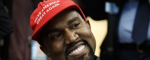 Rapper Kanye West mỉm cười khi nghe câu hỏi của phóng viên trong cuộc họp tại Phòng Bầu dục của Nhà Trắng với Tổng thống Donald Trump, Thứ Năm, ngày 11 tháng 10 năm 2018, tại Washington. - Sputnik Việt Nam