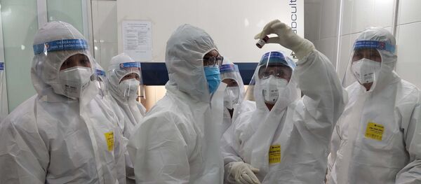 Y bác sỹ Trung tâm Kiểm soát bệnh tật Cao Bằng đang xét nghiệm mẫu máu của bệnh nhân. - Sputnik Việt Nam